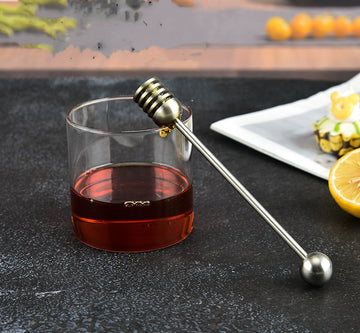Stainless steel honey spoon with long handle, used for honey jars and dessert stirring, by RenFan kitchen tool brand.