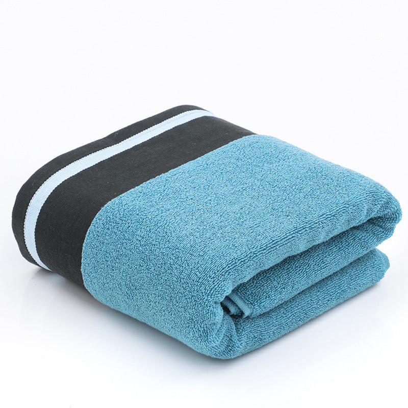 Soft white RenFan cotton bath towel draped over a hook, showcasing plush texture and absorbent quality for bathroom use.