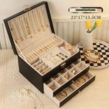 Large leather jewelry box with three-tier drawers for storing necklaces, earrings, and bracelets in a home accessories storage container.