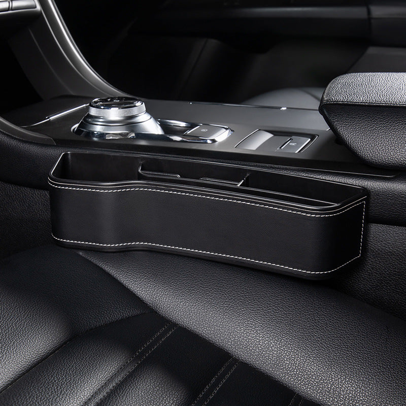 Aiqi car seat gap storage box fitting between car seats to hold small items and prevent them from falling into the gap.