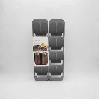 Compact spice bottle rack for small kitchen counter organization.