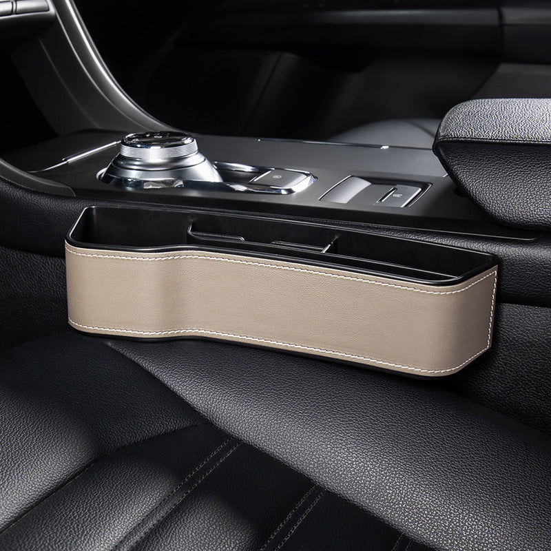Aiqi car seat gap storage box fitting between car seats to hold small items, designed for organized vehicle storage.