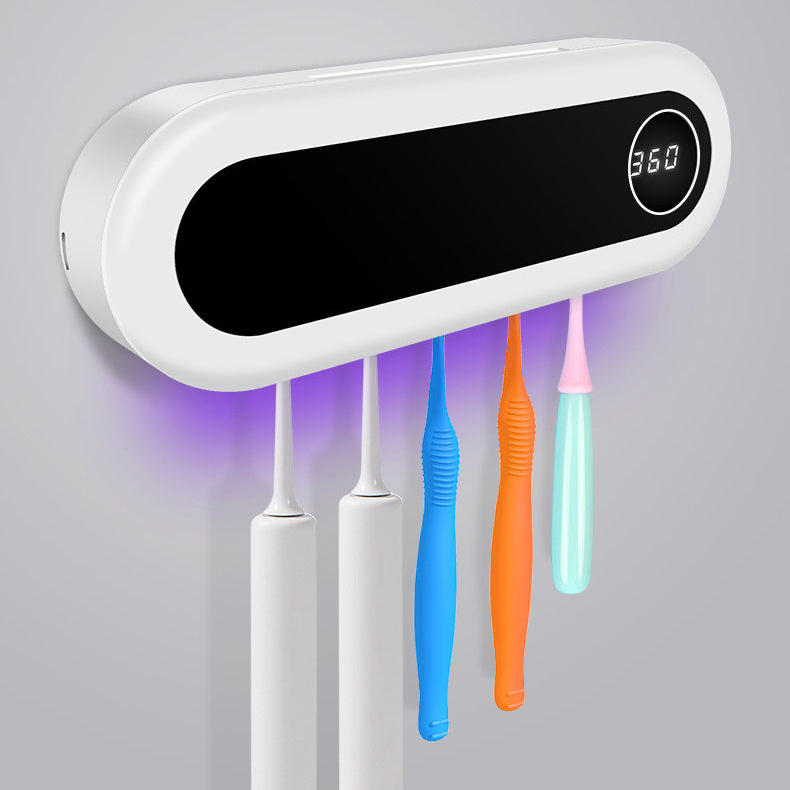 Wall-mounted Jingqian toothbrush holder with UV sterilizer, toothpaste dispenser, and bathroom accessories in a modern bathroom setting.