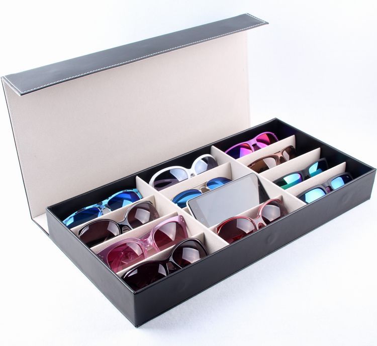 Black glasses storage box with grid compartments, PU leather exterior, ideal for sunglasses display and home organization.