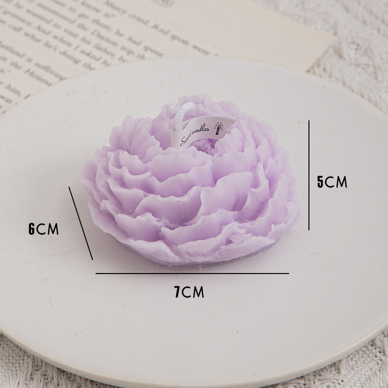 A handmade Aiqi peony flower aromatherapy candle with a white ceramic holder and decorative peony design.