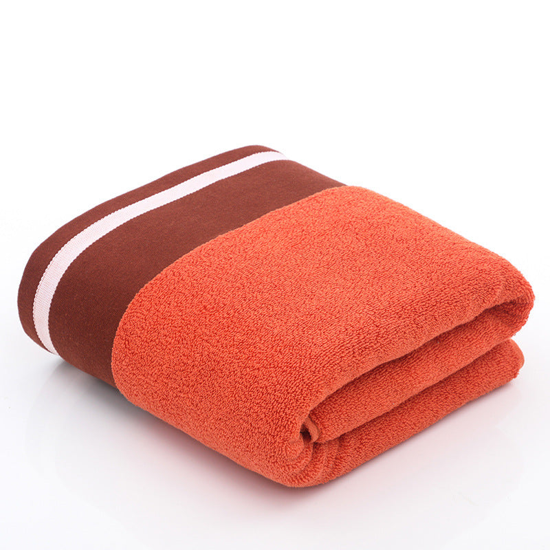 White cotton bath towel from RenFan, soft and plush, shown hanging in a bathroom setting.