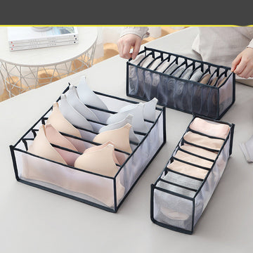 Aiqi foldable mesh storage box for home use, showing its breathable mesh design and collapsible structure for organizing clutter.