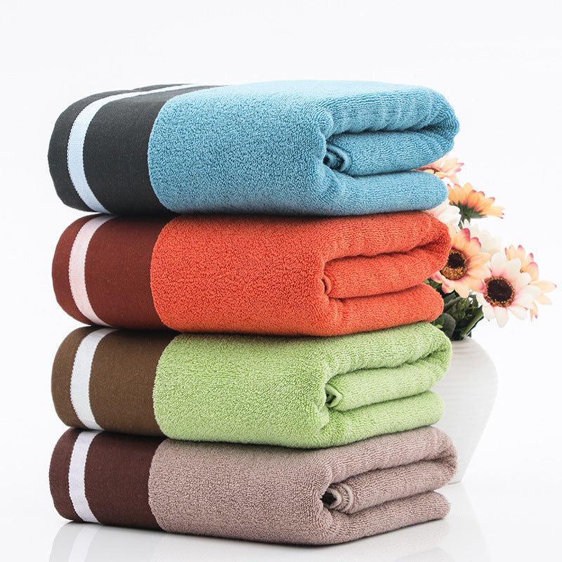 Soft cotton bath towel hanging in a bathroom, designed for absorbent daily drying and comfort.