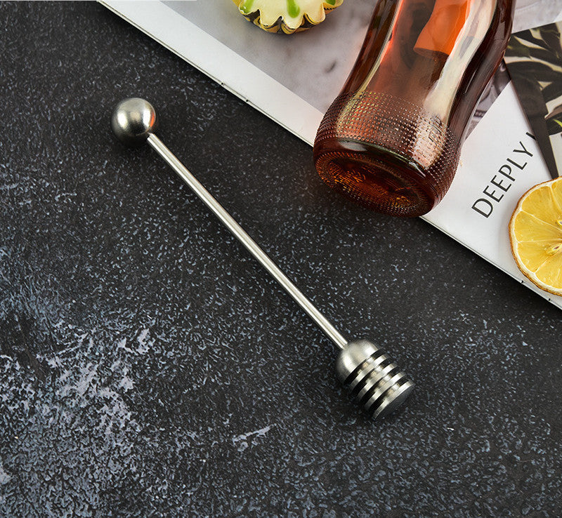 Stainless steel honey spoon with long handle for honey jars, ideal for stirring and serving desserts, by RenFan kitchen tools.