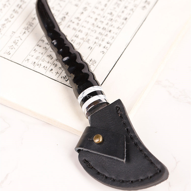 Portable Damascus steel sheep horn incense knife for incense supplies, with a sleek, traditional design.