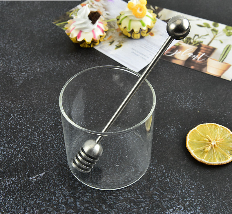 Stainless steel honey spoon with long handle, used for honey jars and dessert stirring, by RenFan kitchen tool brand.