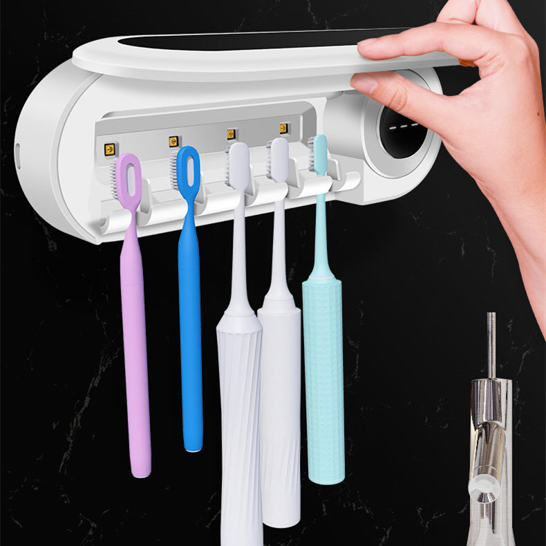 Wall-mounted Jingqian toothbrush holder with UV sterilizer, toothpaste dispenser, and bathroom accessories in a modern bathroom.