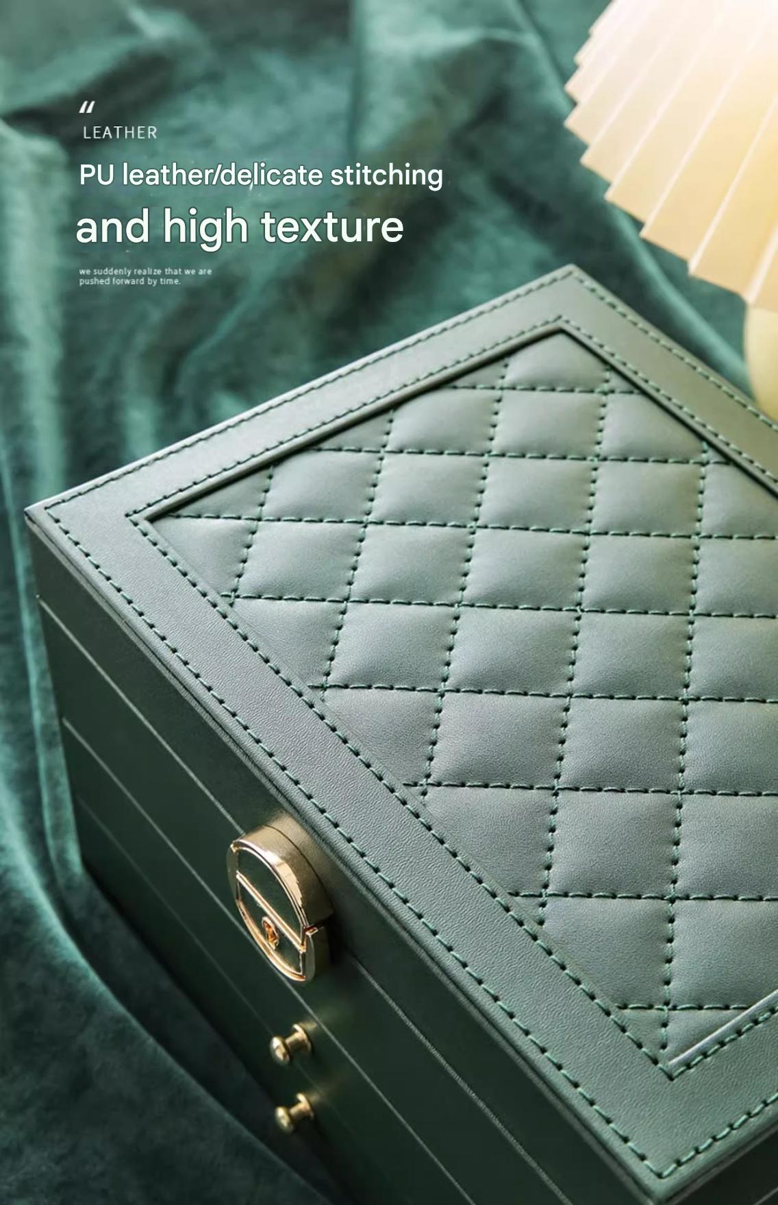 Large leather jewelry box by PETART with three-tier drawers, gold accents, and compartments for necklaces, earrings, and bracelets.