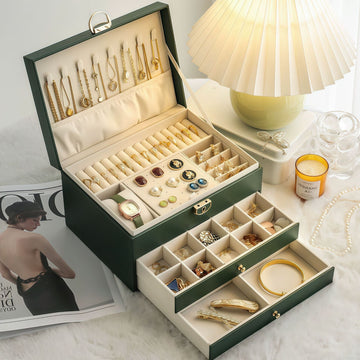 Large leather jewelry box by PETART with three-tier drawers, storing necklaces, earrings, and bracelets in elegant home accessories.