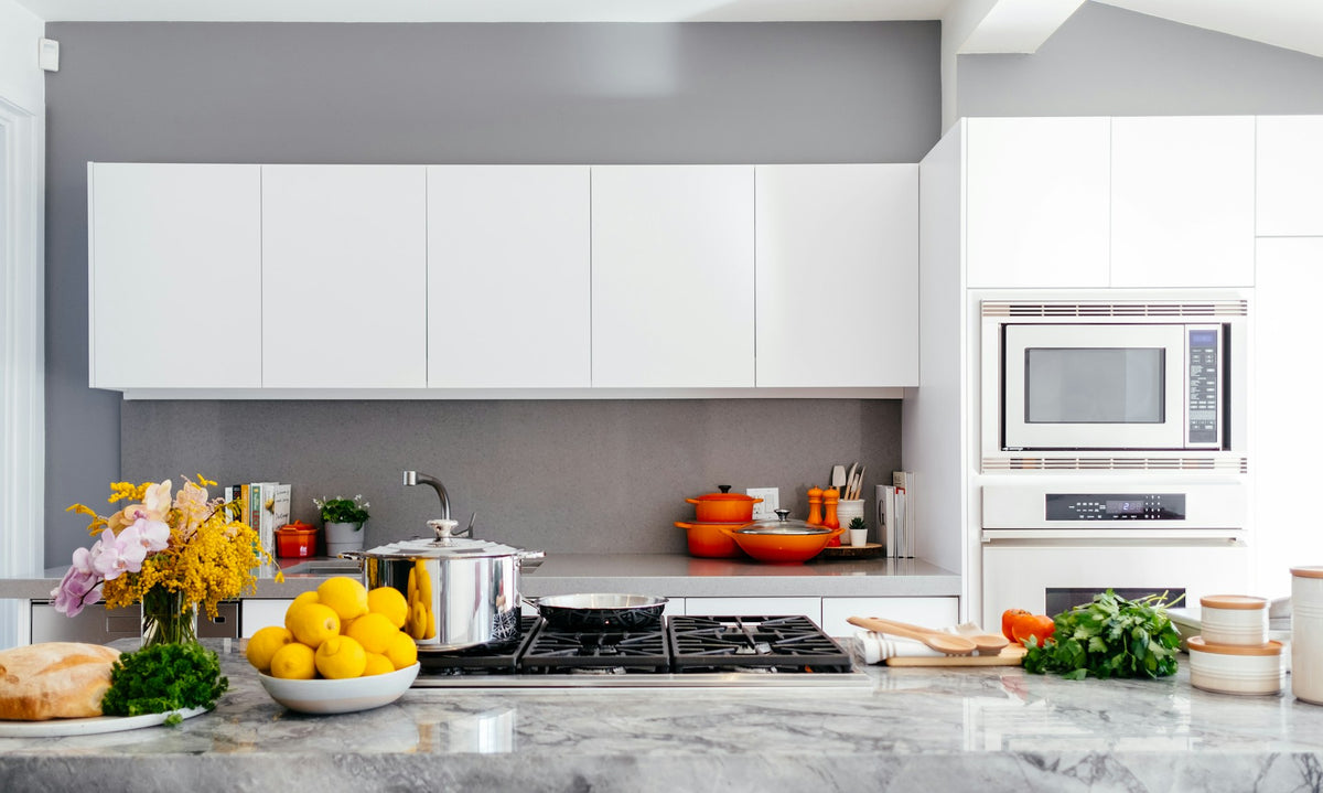 Bright, organized kitchen with warm wood, clean counters, and practical everyday cooking space.